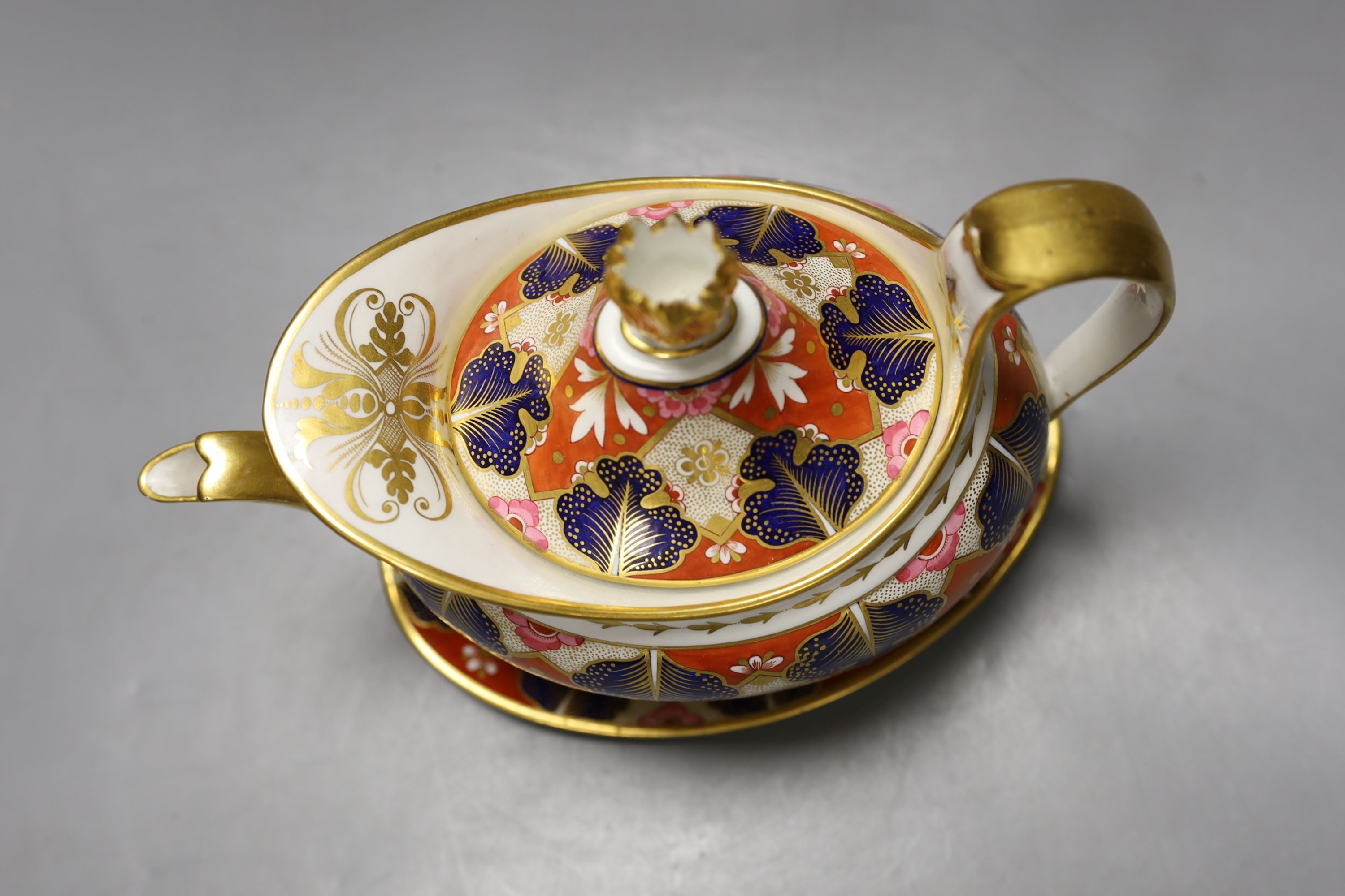 A Barr Flight and Barr Worcester teapot cover and stand painted with an Imari pattern, c.1805, 23 cm long